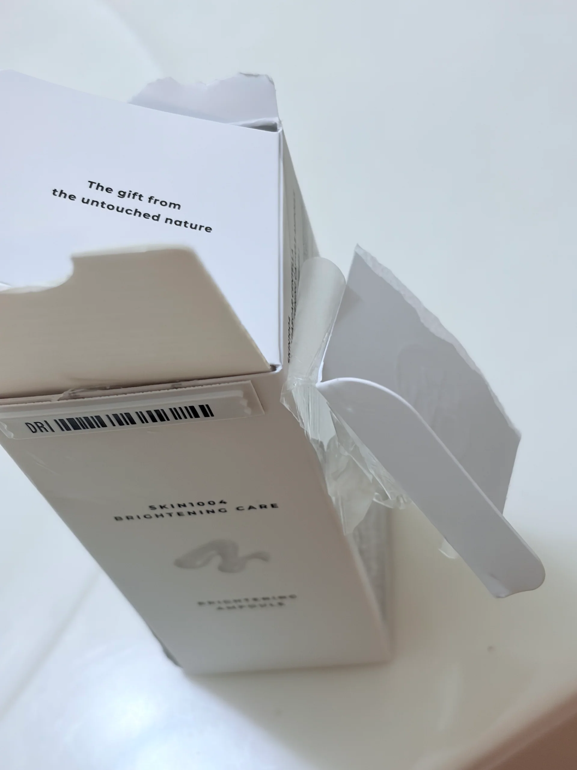 Opened SKIN1004 Brightening Care carton with The gift from the untouched nature printed on its inner flap.
