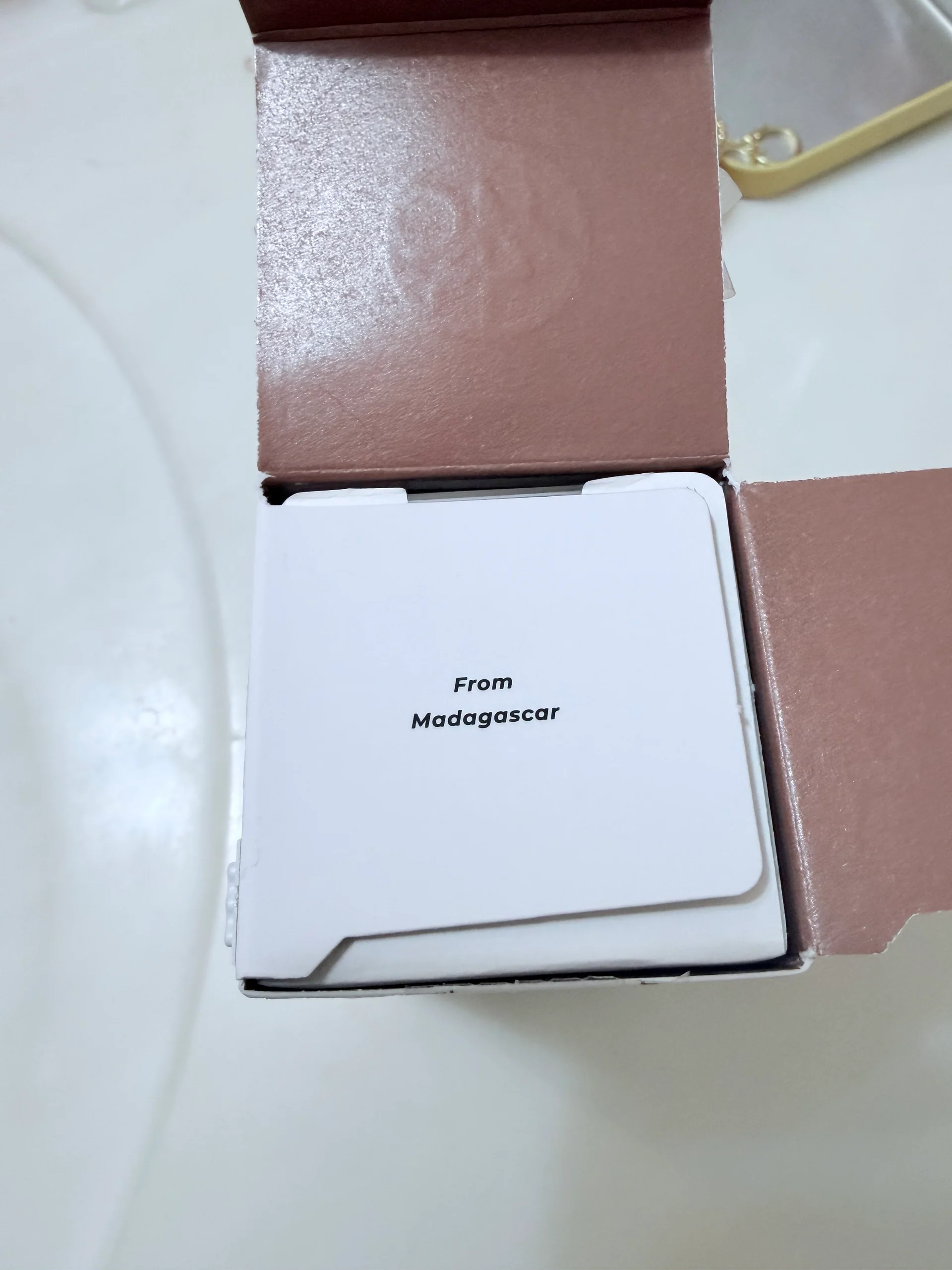 Brown-lined carton with From Madagascar visible on the next white flap.